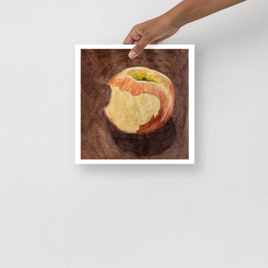 Product mockup of a watercolor painting print that depicts a red apple with a bite against a brown background