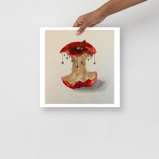 Product mockup of a watercolor painting print of a red apple with a bite taken out, hanging stars, and a beige background.