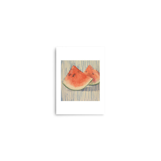 Product mockup of Two watermelon slices on a striped fabric background