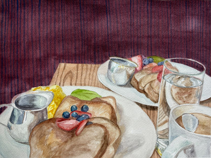 Watercolor painting of a breakfast table scene with plates of toast, blueberries, fruit, a glass of water, creamers, and a striped burgundy background.