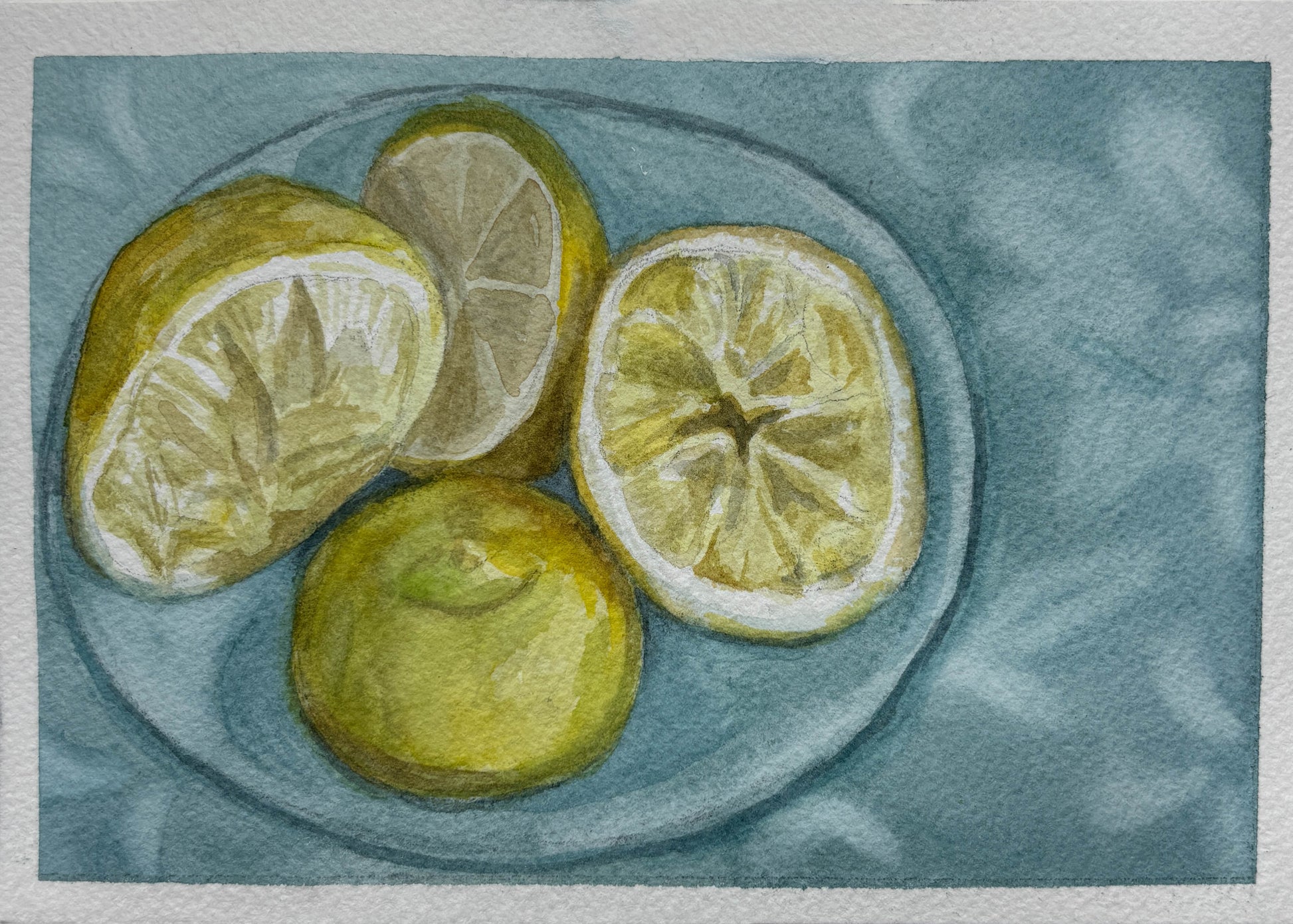 Watercolor painting of four lemons, including two halves and one whole lemon, arranged on a round plate against a textured blue-gray background.