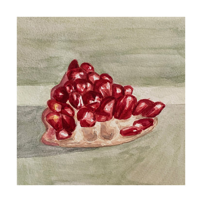 Red pomegranate chunk on a greyish green background