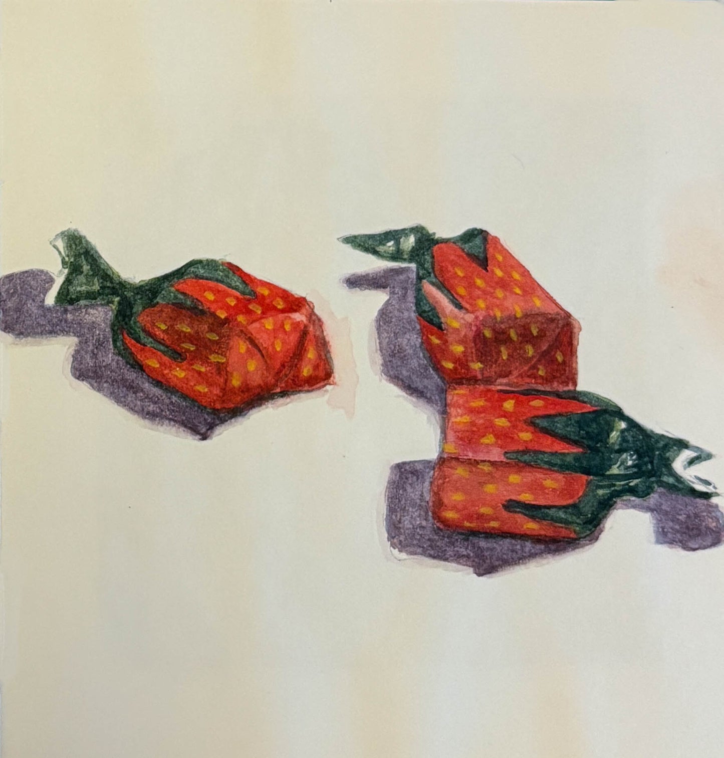 Three red strawberry candies on a white background 