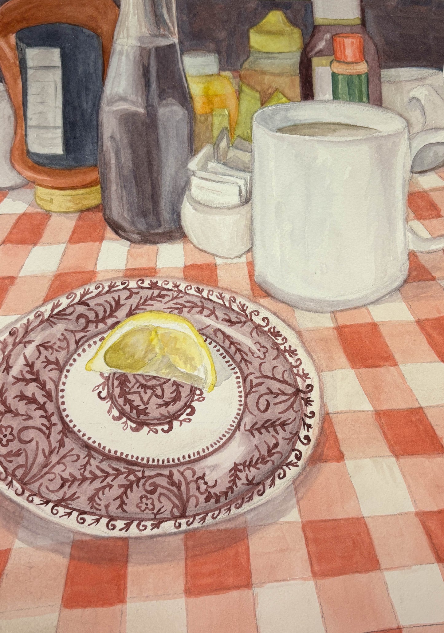 Table setting with a plate, mug, and various items on a checkered tablecloth