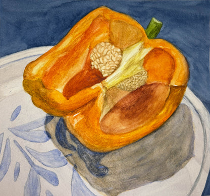 watercolor painting of a halved orange bell pepper on a white plate with a design against a blue background. 