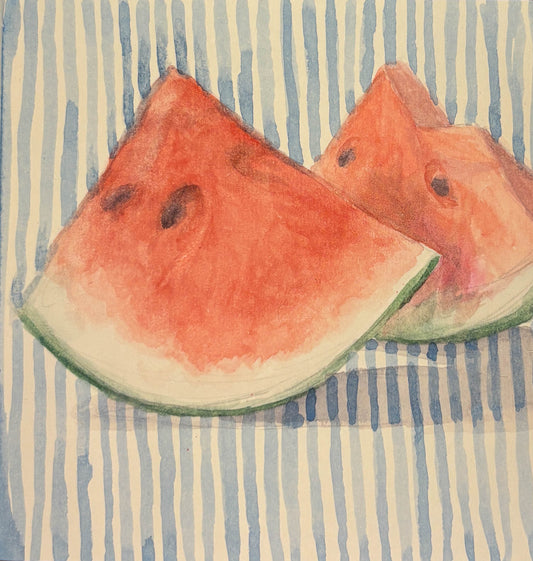 Two watermelon slices on a striped fabric background