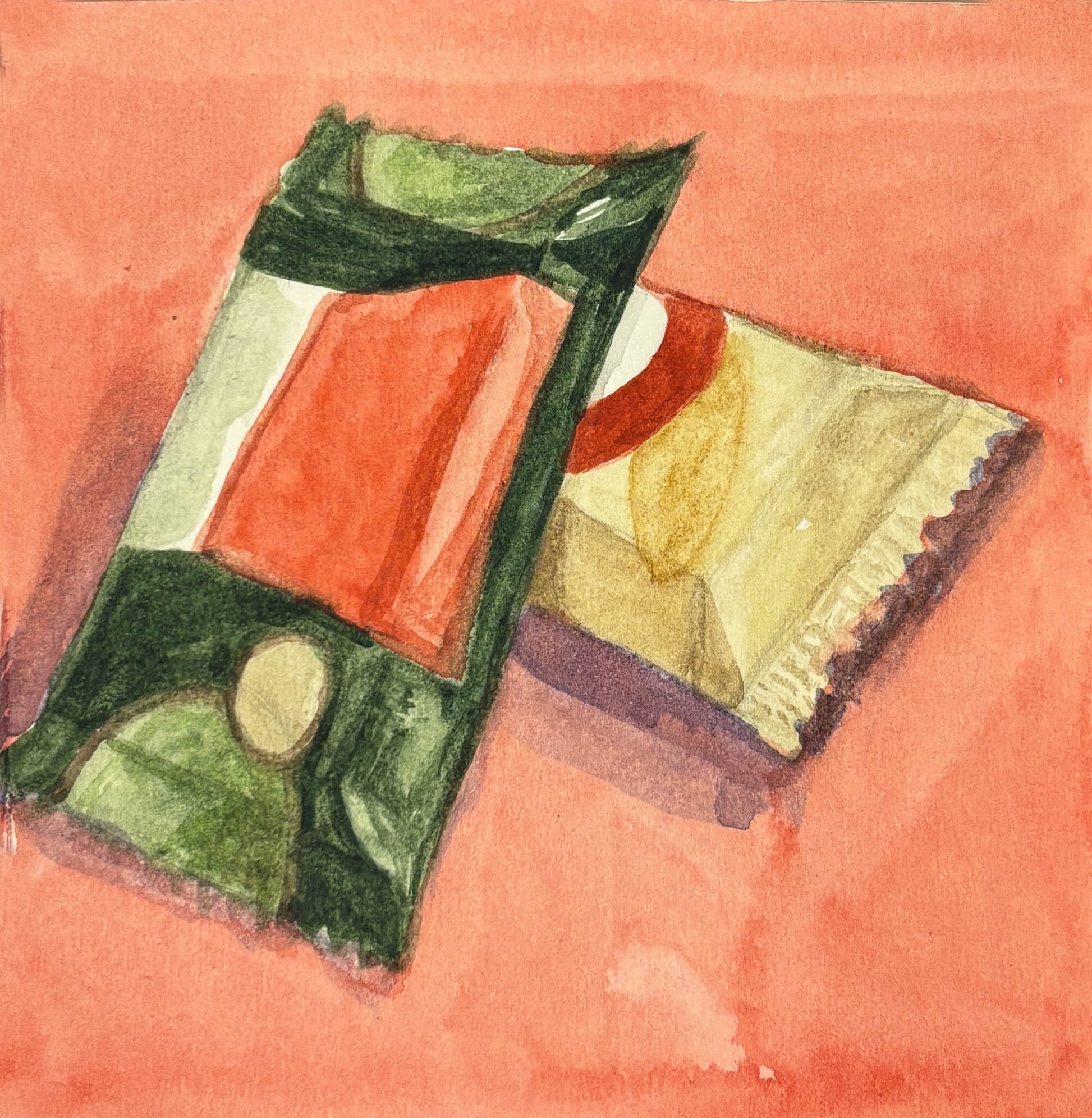 Two Kit-Kat candy bars on a red background