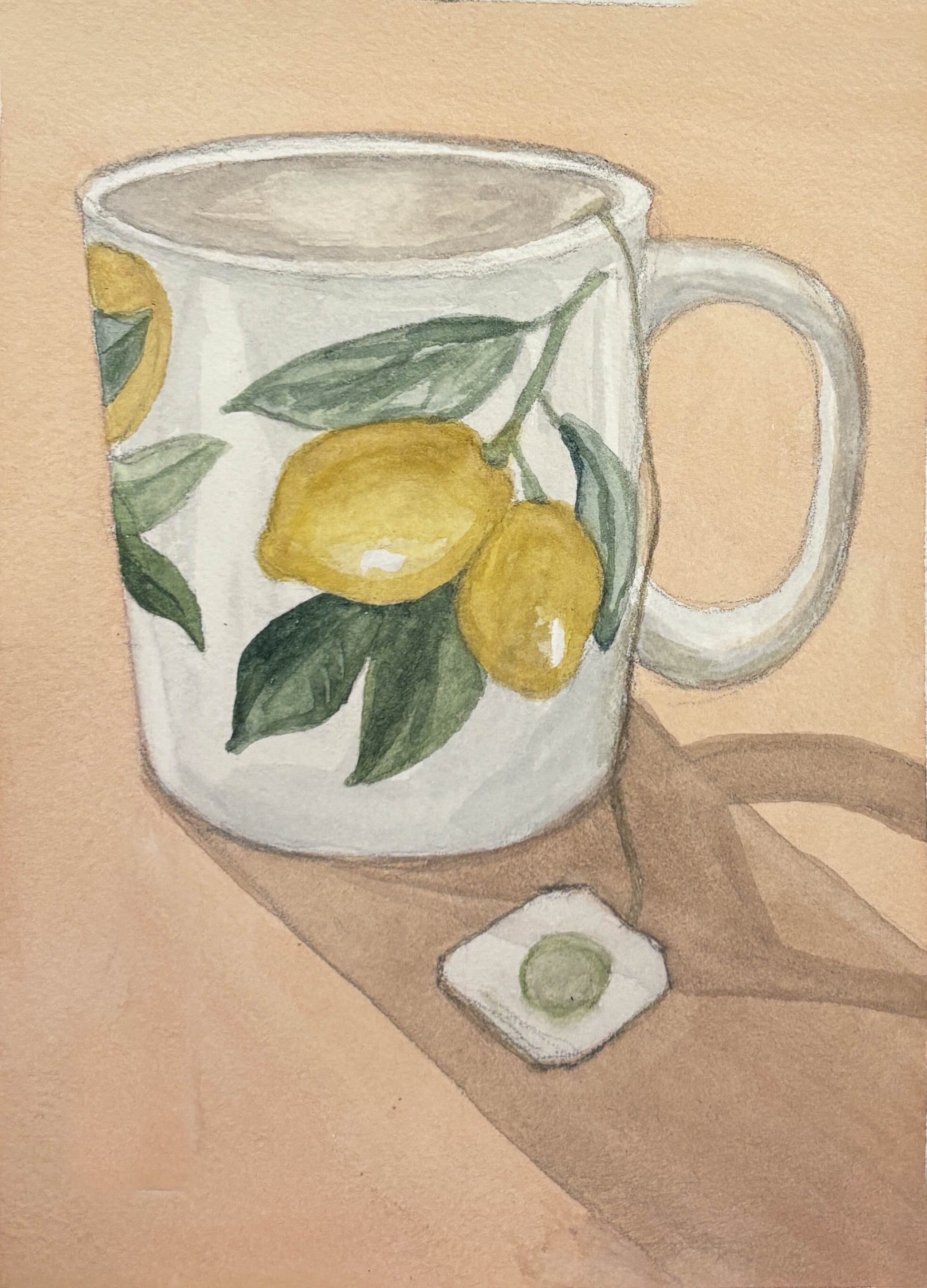 Ceramic mug with lemon design on a beige background
