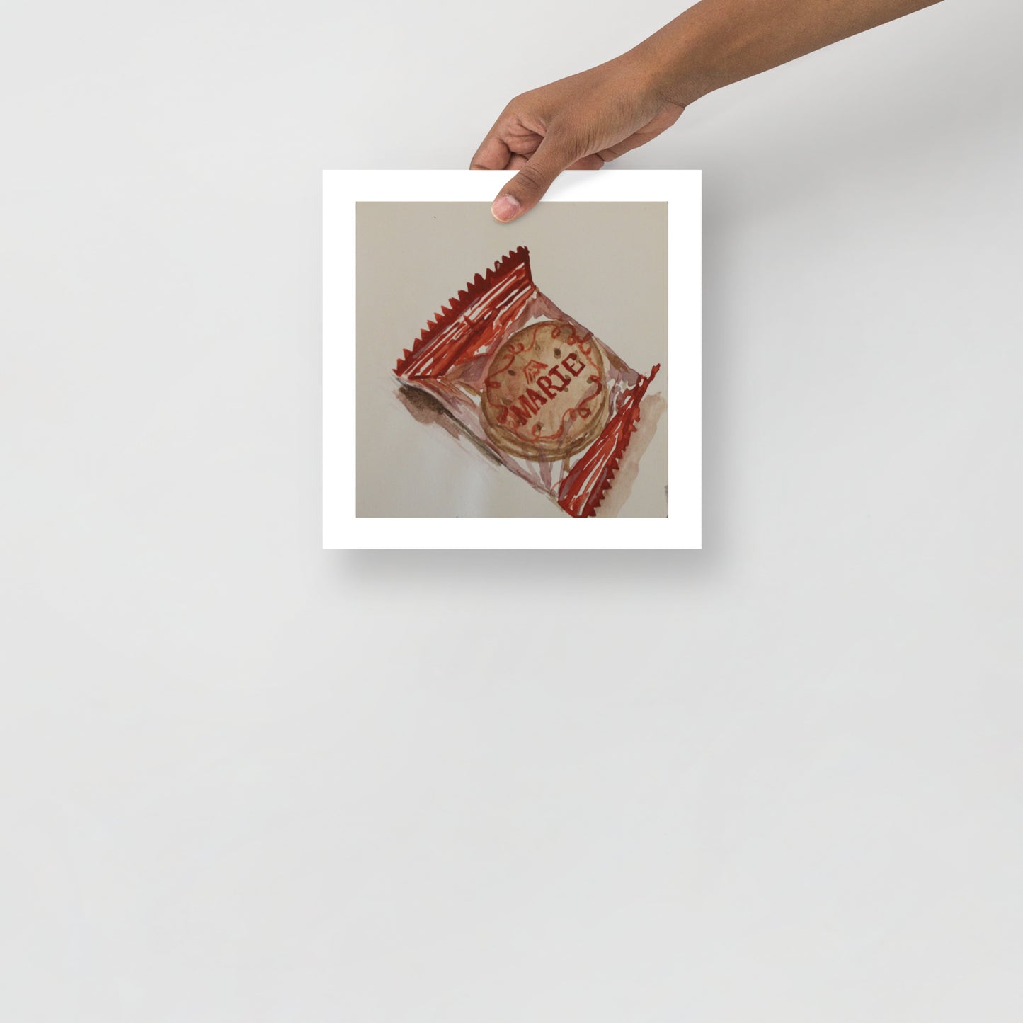 Product mockup of a watercolor print that depicts a cookie with 'Marie' branding in a red wrapper on a beige background