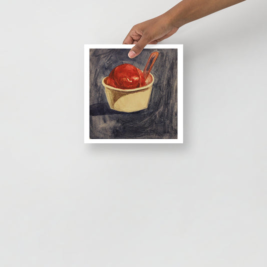 Product mockup of a watercolor print that depicts an artistic depiction of a raspberry gelato in a white cup with a spoon on a textured dark background