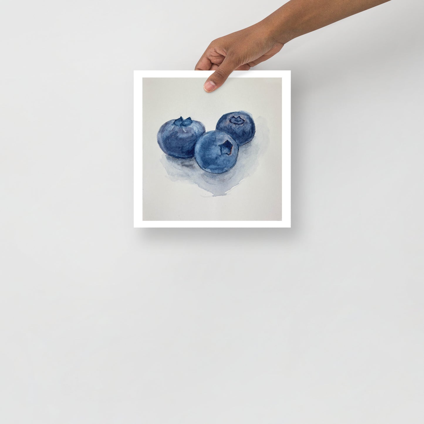 Product mockup of Watercolor painting of three blueberries on a white background