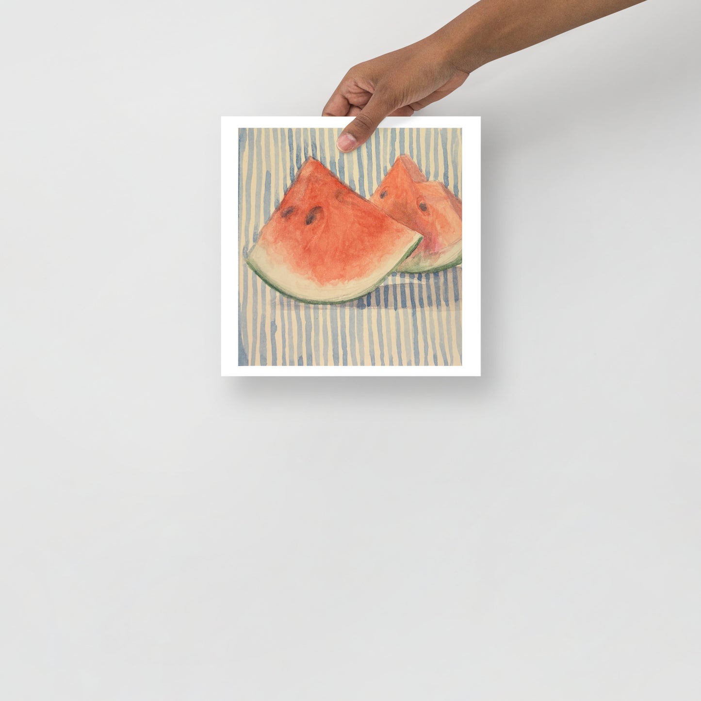 Product mockup of Two watermelon slices on a striped fabric background