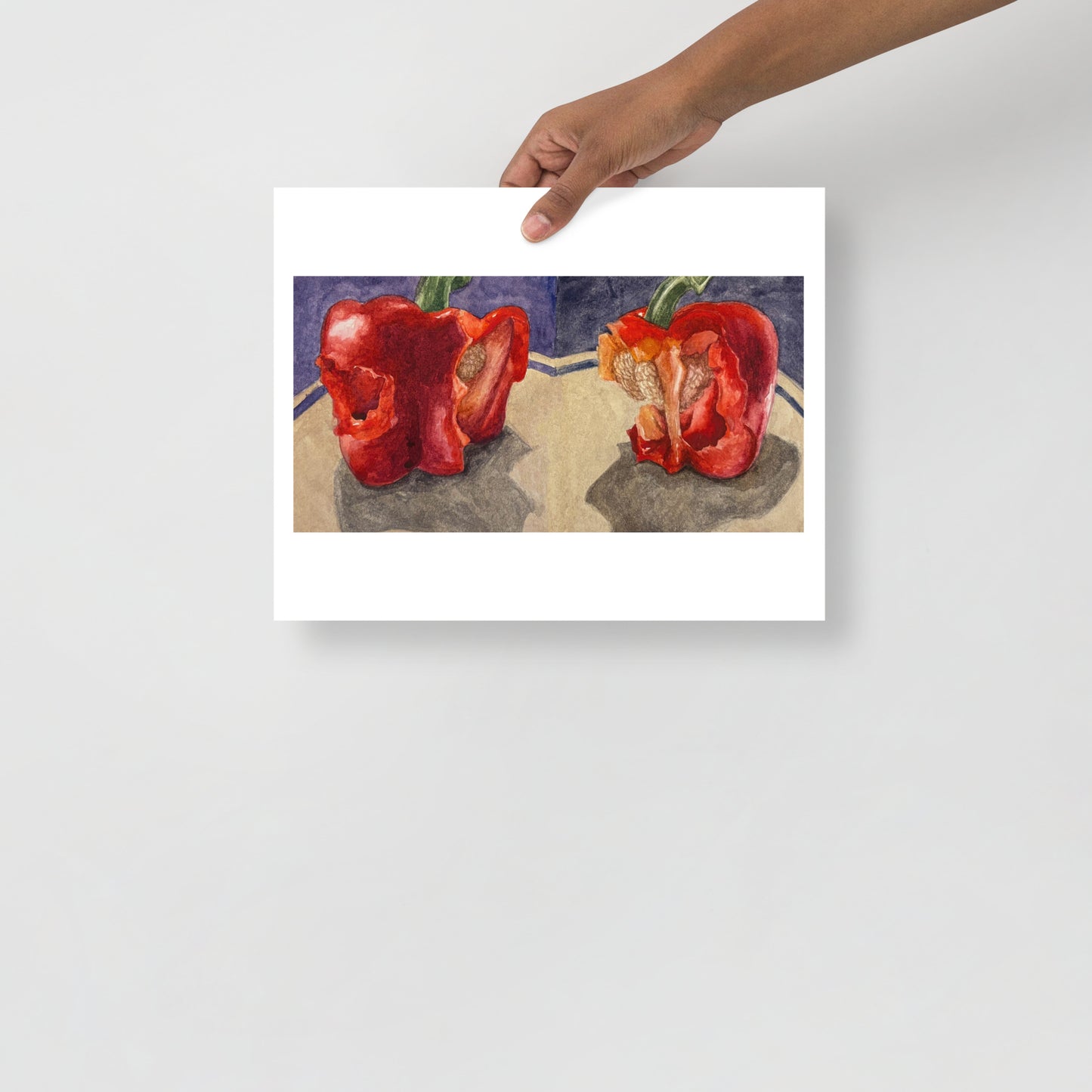 Product mockup of a watercolor print that depicts two red bell peppers with bites taken out of them, against  purple background. 