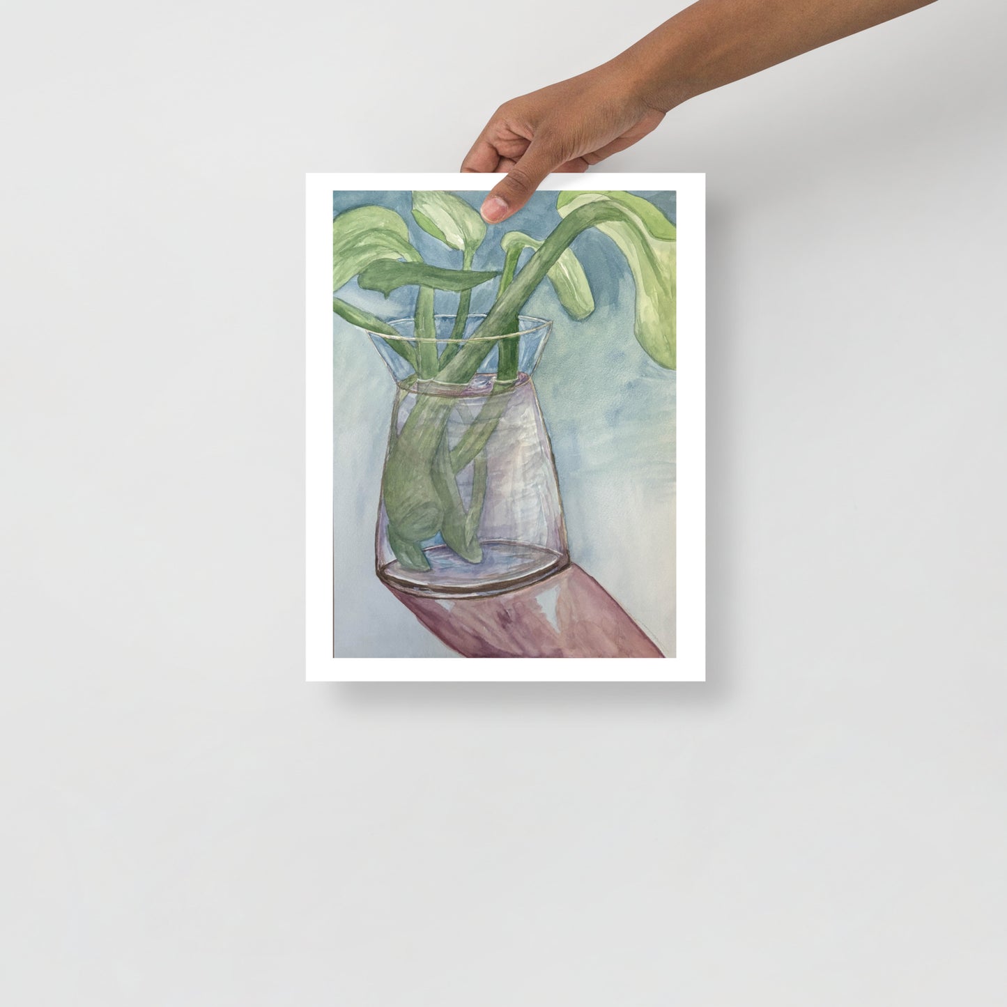 Art print of a glass vase with green leaves on a white background