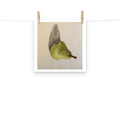 Product mockup of a watercolor print that depicts a sideways green pear against a white background 