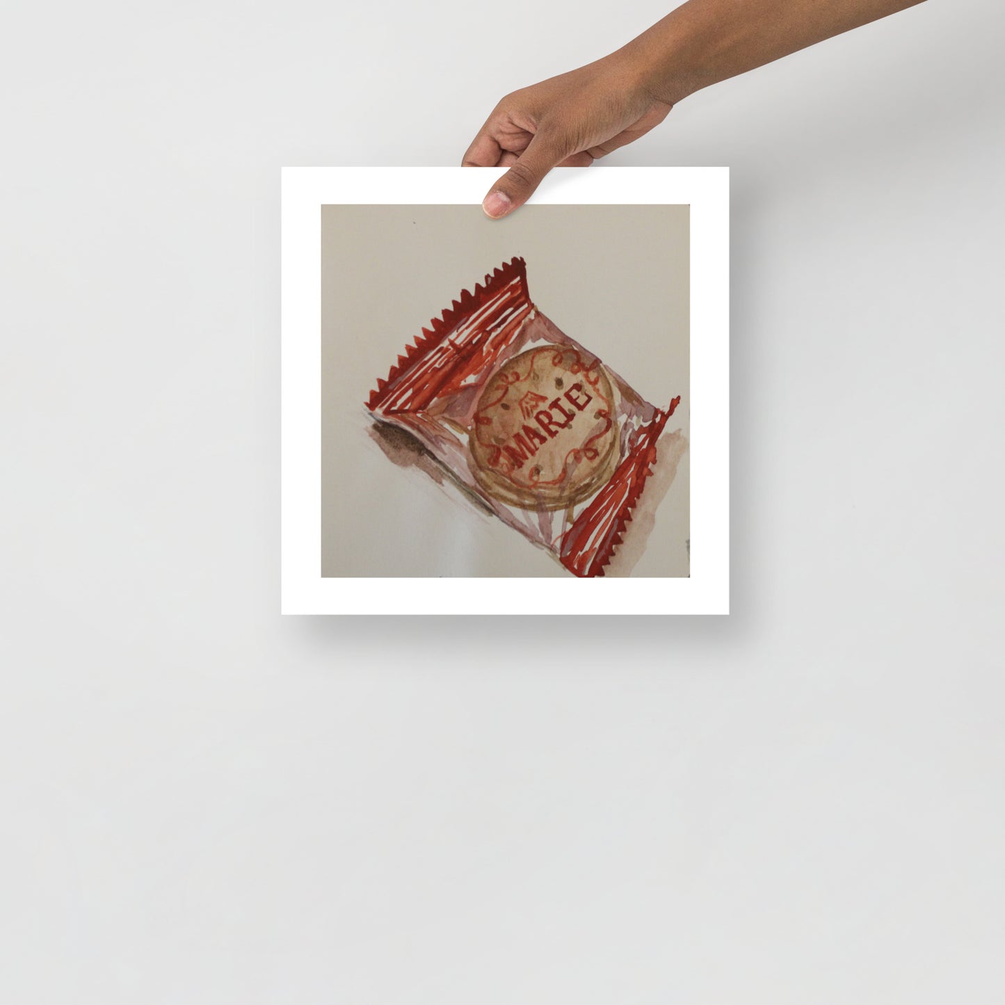 Product mockup of a watercolor print that depicts a cookie with 'Marie' branding in a red wrapper on a beige background