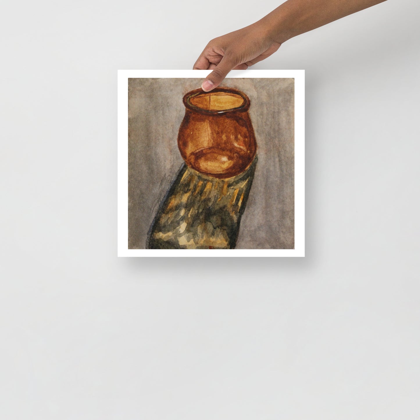 Product mockup of a watercolor painting that depicts an atistic depiction of an amber jar on a textured surface