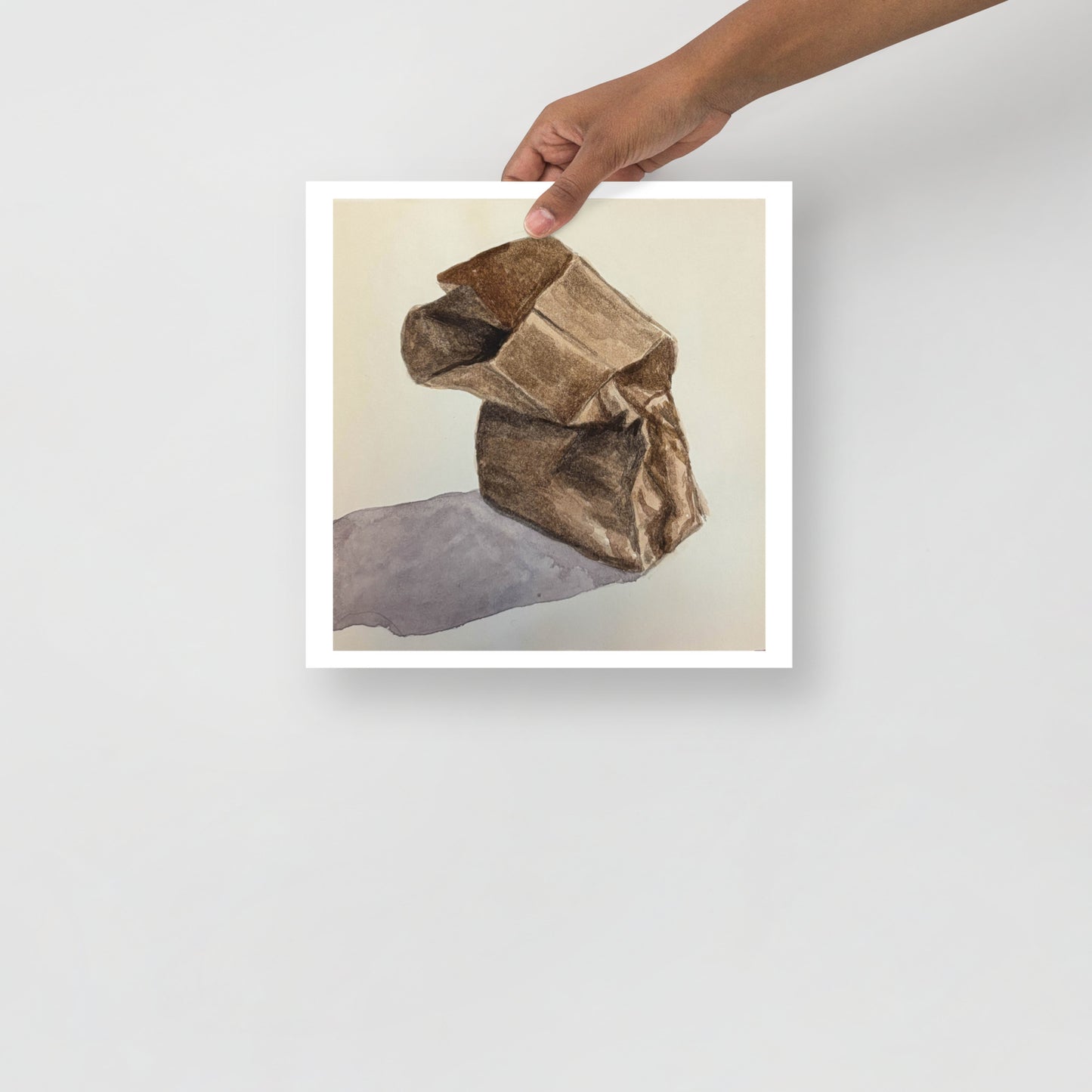 Product mockup of a watercolor print that depicts a brown paper bag on a light beige background