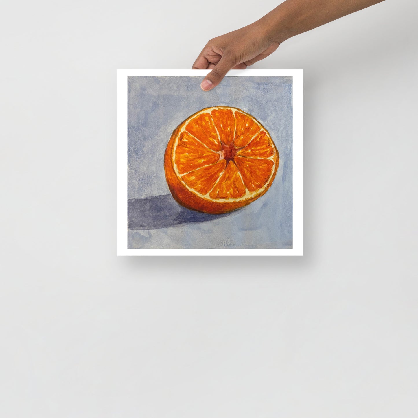 Product mockup of a watercolor painting print of Sliced orange on a textured blue background