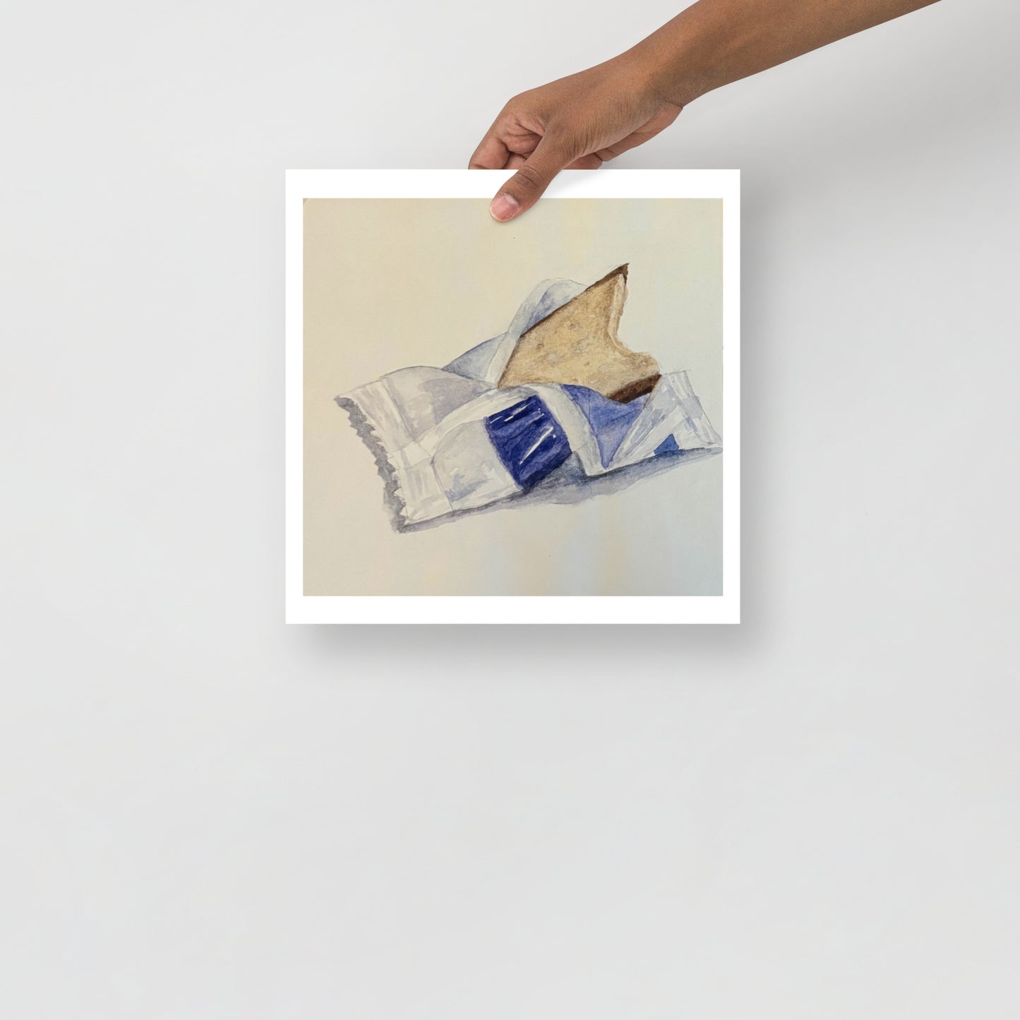 Product mockup of a watercolor print that depicts an artistic depiction of a candy half opened on a white background 