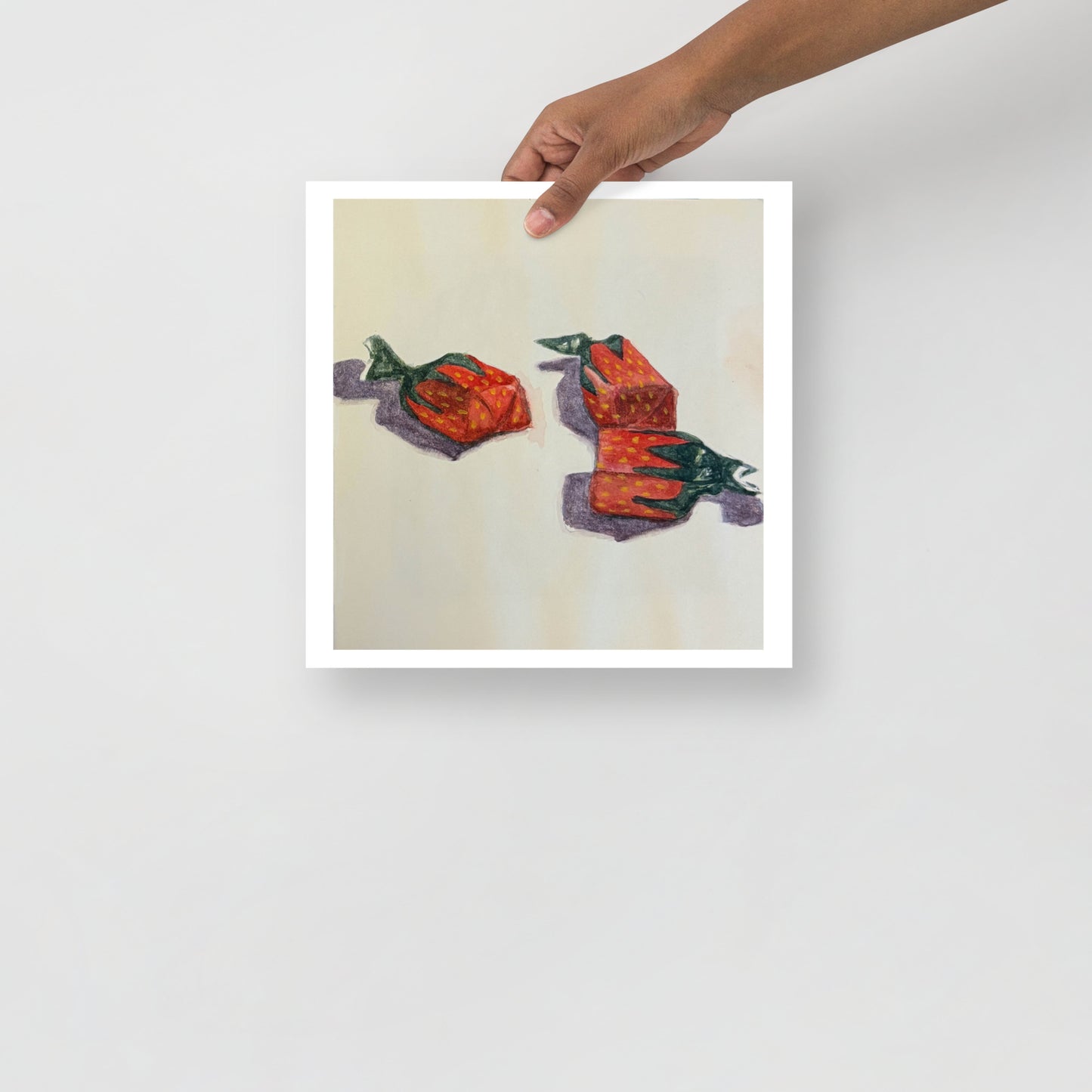 Product mockup of a watercolor print that depicts three red strawberry candies on a white background  