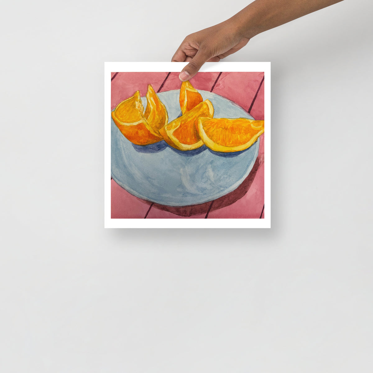 Product mockup of Sliced oranges on a blue plate with a pink tiled background