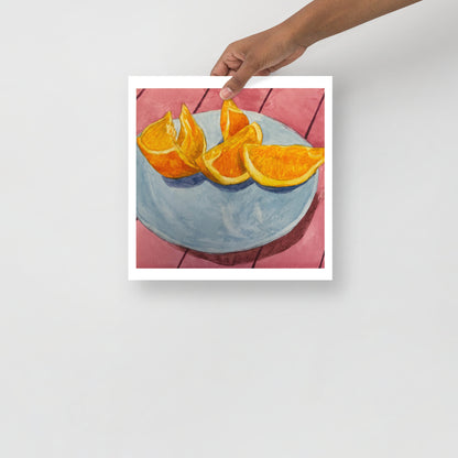 Product mockup of Sliced oranges on a blue plate with a pink tiled background