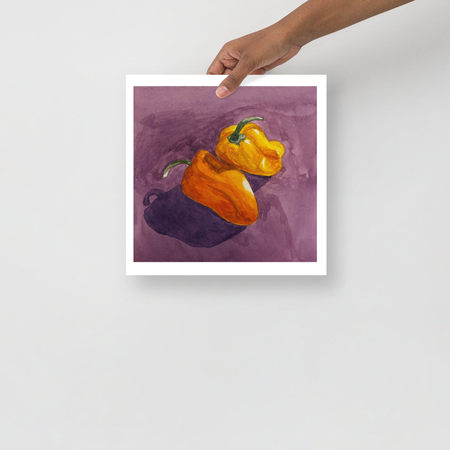 Product mockup of Two peppers, one orange and one yellow, on a purple background