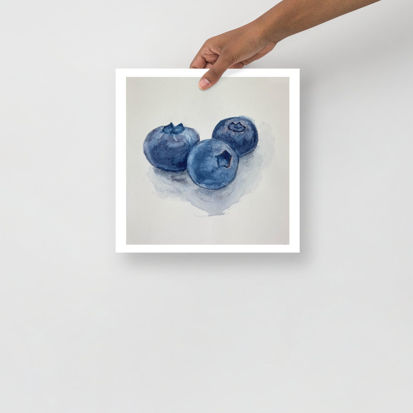 Product mockup of Watercolor painting of three blueberries on a white background