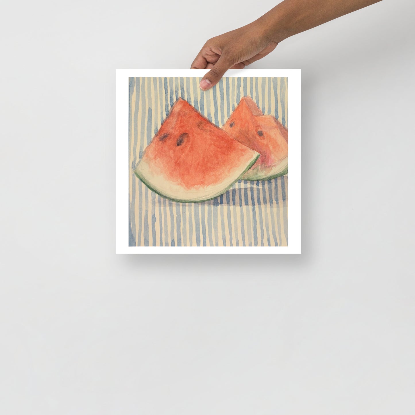 Product mockup of Two watermelon slices on a striped fabric background