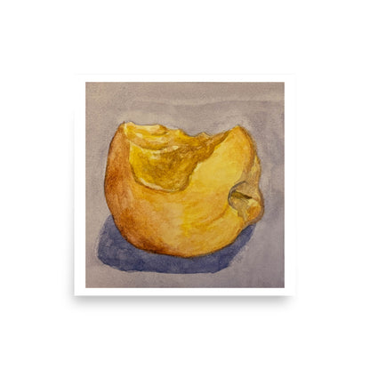 Product mockup of a watercolor painting that depicts a golden apple with a bite taken out of it against a greyish background. 