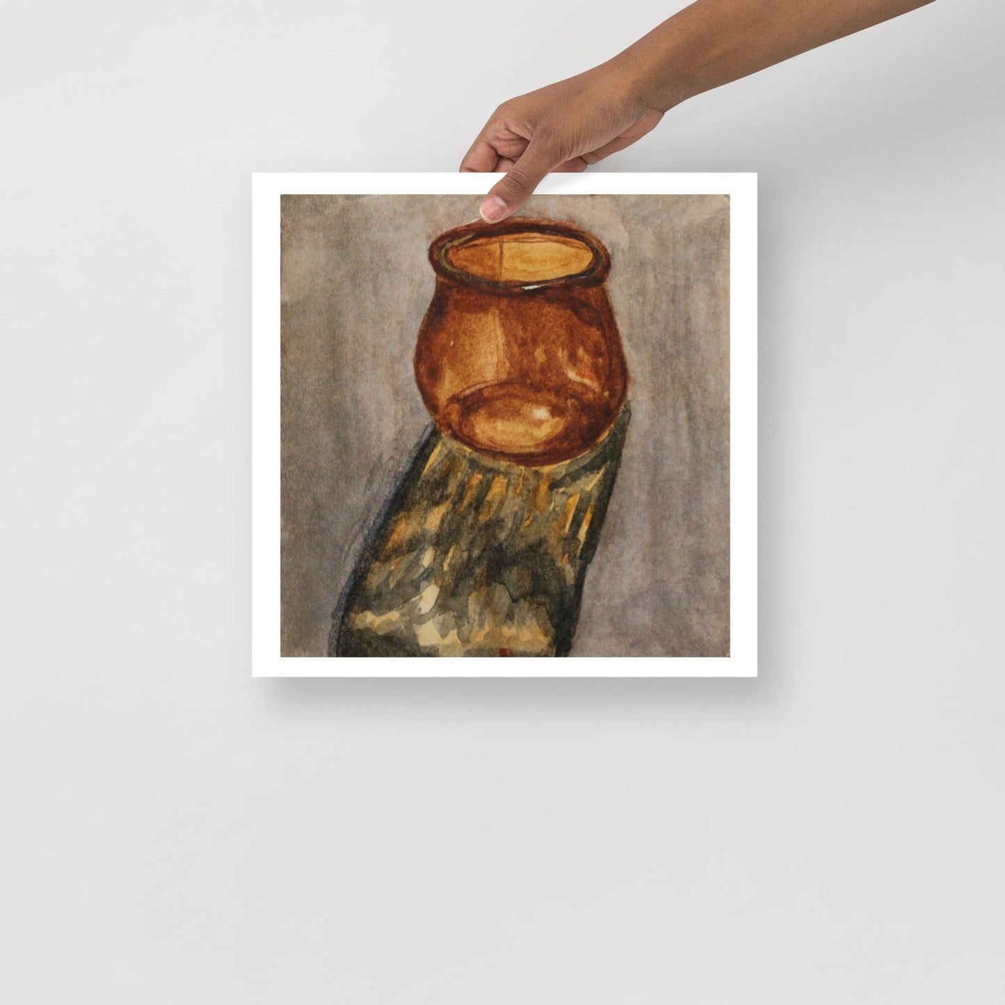 Product mockup of a watercolor painting that depicts an atistic depiction of an amber jar on a textured surface