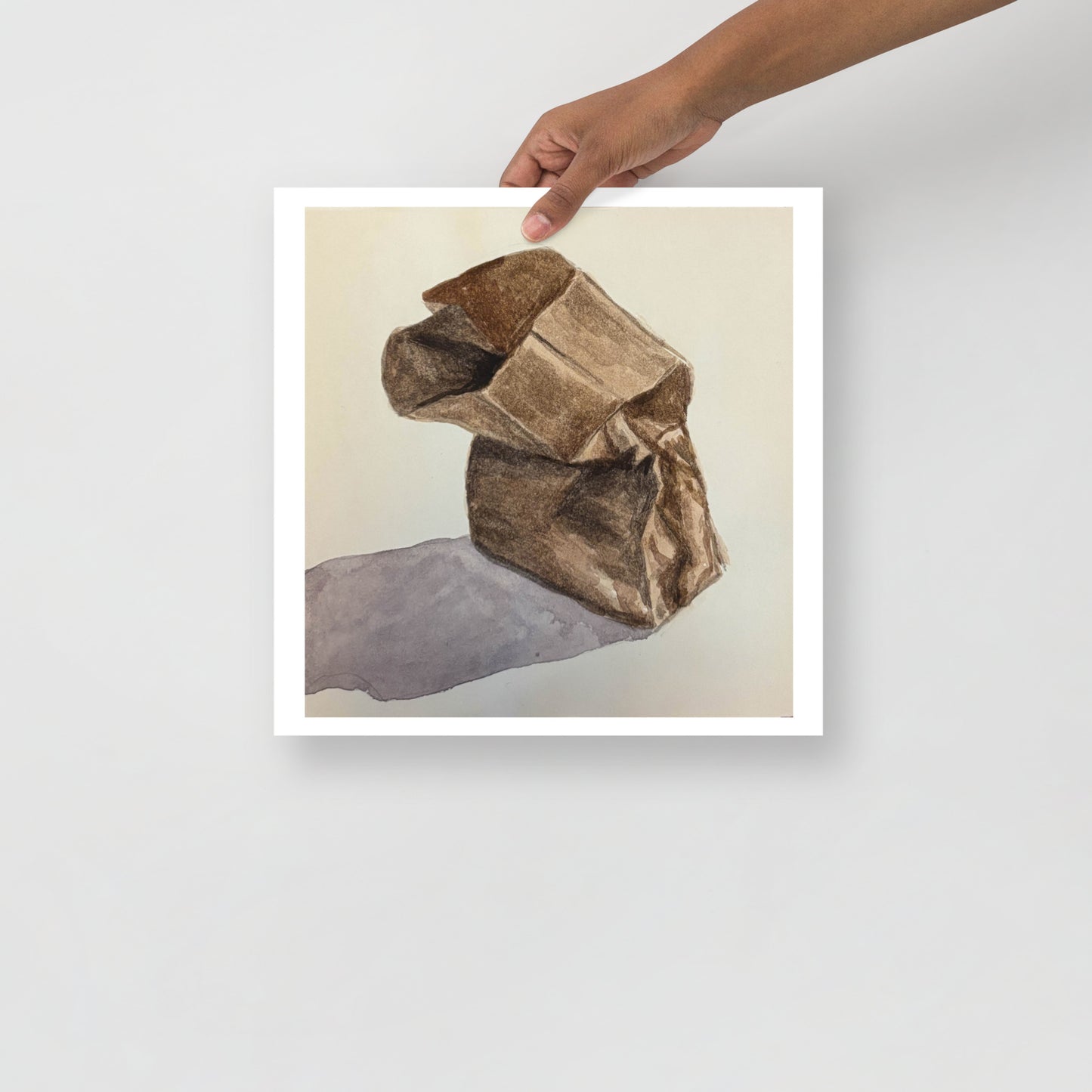 Product mockup of a watercolor print that depicts a brown paper bag on a light beige background