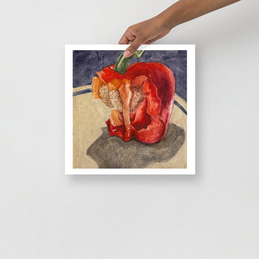 Product mockup of a watercolor painting of a red bell pepper with bites taken out of it on a textured surface with a dark background