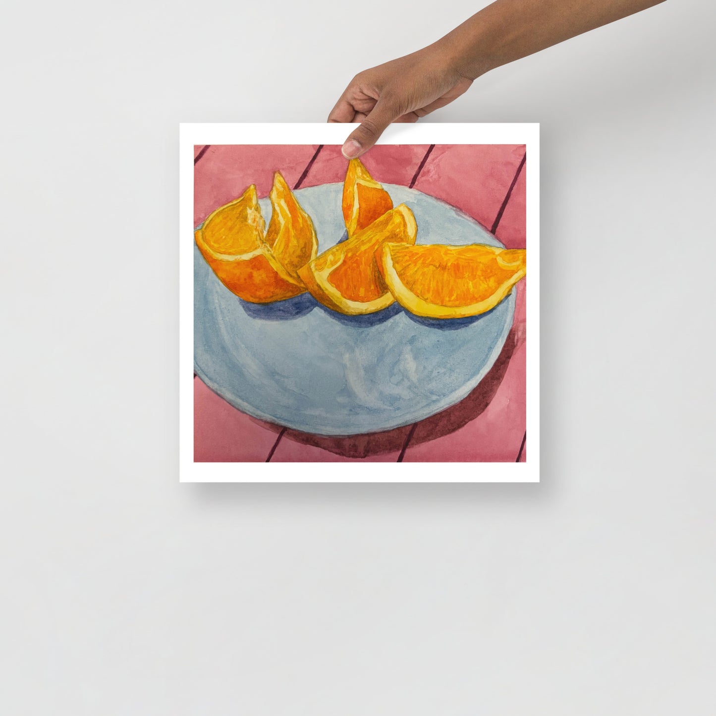 Product mockup of Sliced oranges on a blue plate with a pink tiled background