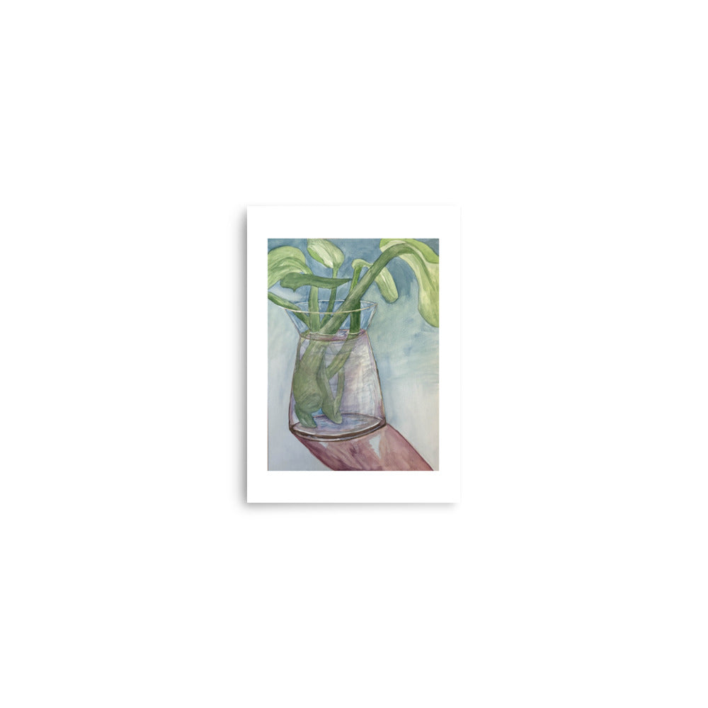 Art print of a glass vase with green leaves on a white background