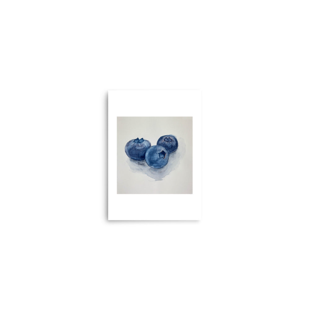 Three blueberries on a white background