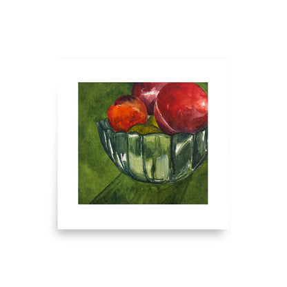 Product mockup of a watercolor painting print that depicts a green bowl with red fruit against a green background. 